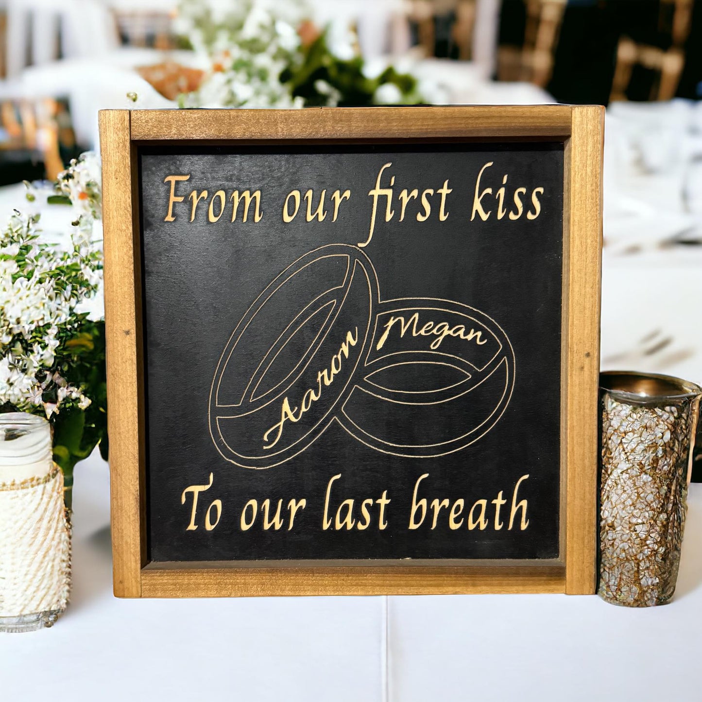 Framed carved wood sign with black background that reads “From Our First Kiss To Our Last Breath” and personalized wedding band design – anniversary gift idea with marriage quote