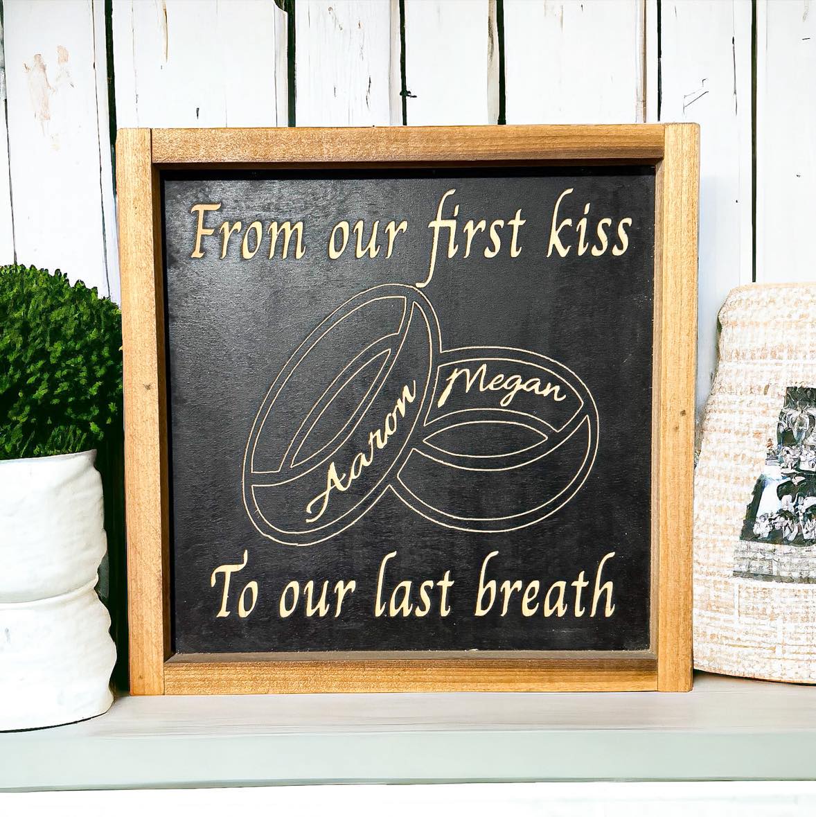 Framed carved wood sign with black background that reads “From Our First Kiss To Our Last Breath” and personalized wedding band design – anniversary gift idea with marriage quote