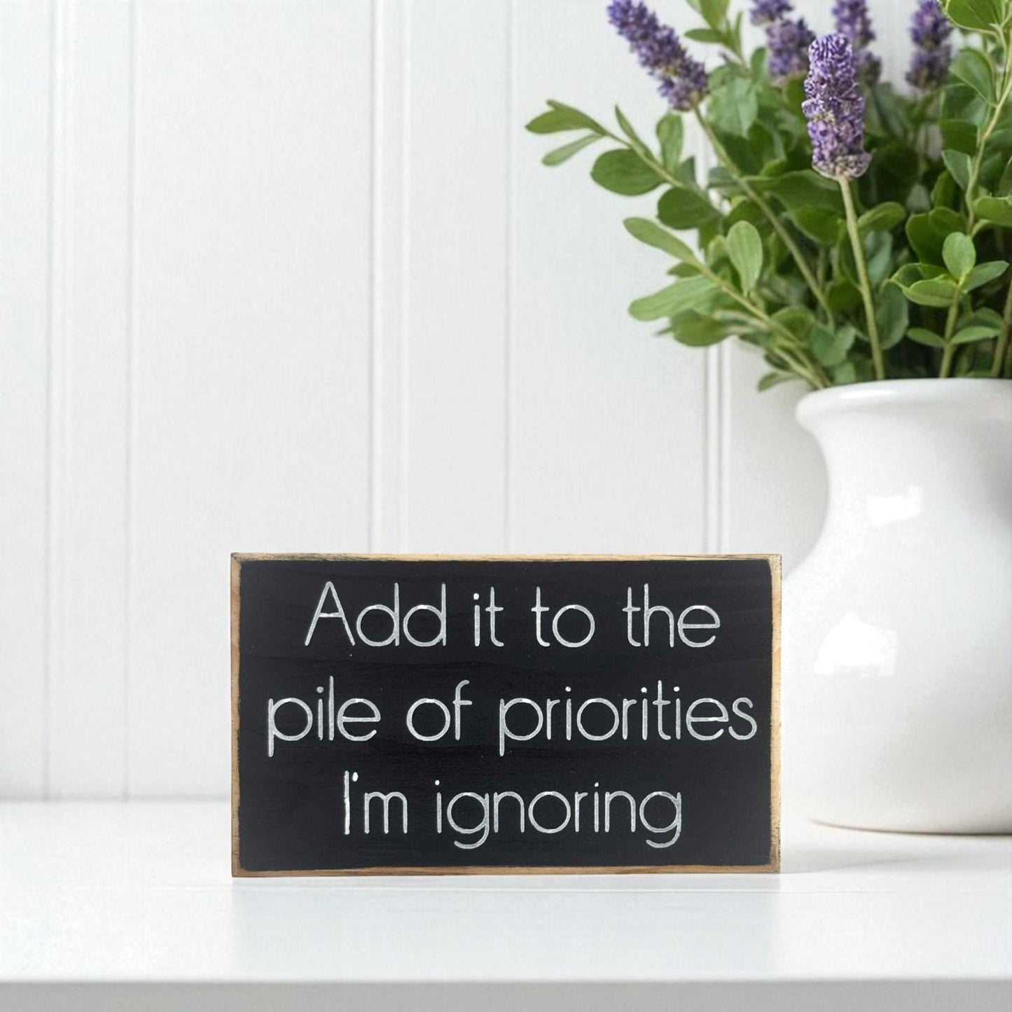 Handmade funny office desk sign reading “Add It to the Pile of Priorities I’m Ignoring” – sarcastic office decor, 3.5" x 6" wood block, witty workplace gift.