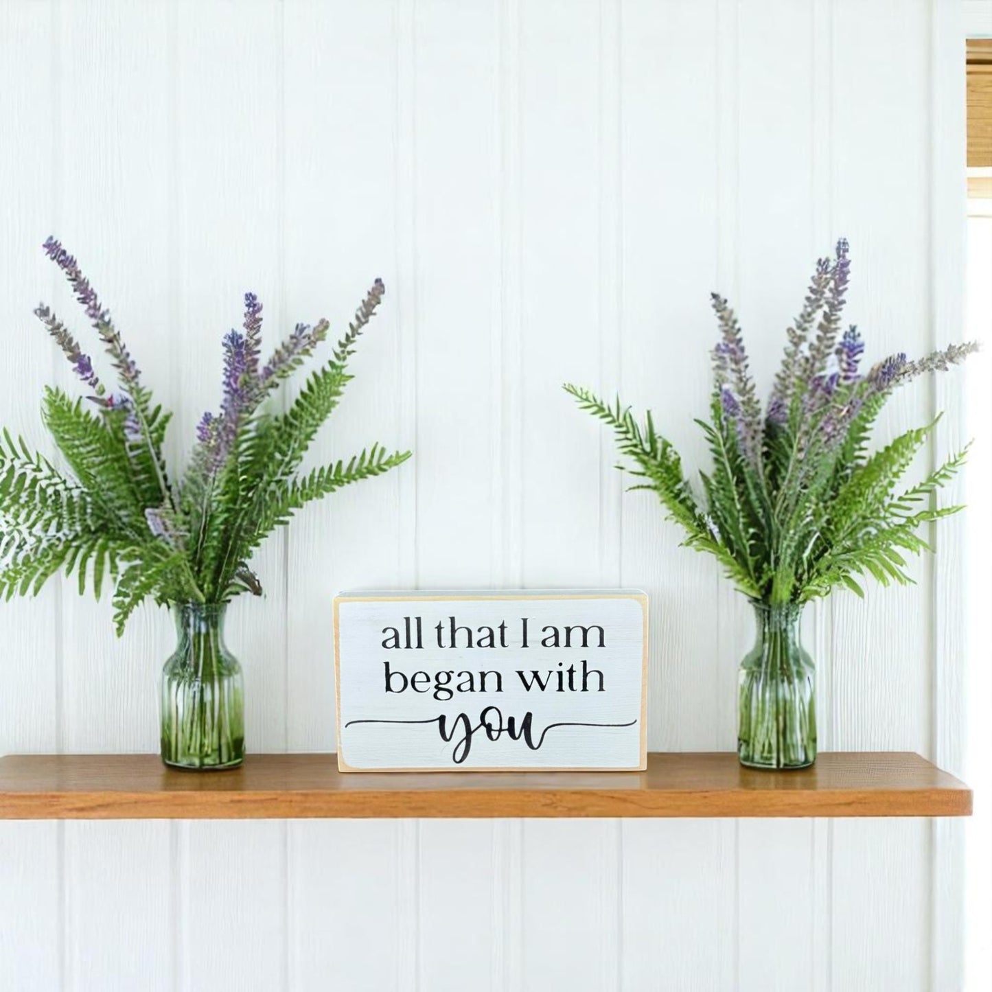 White wooden block sign with black text that reads “All That I Am Began With You” – meaningful gift for Mother’s Day.