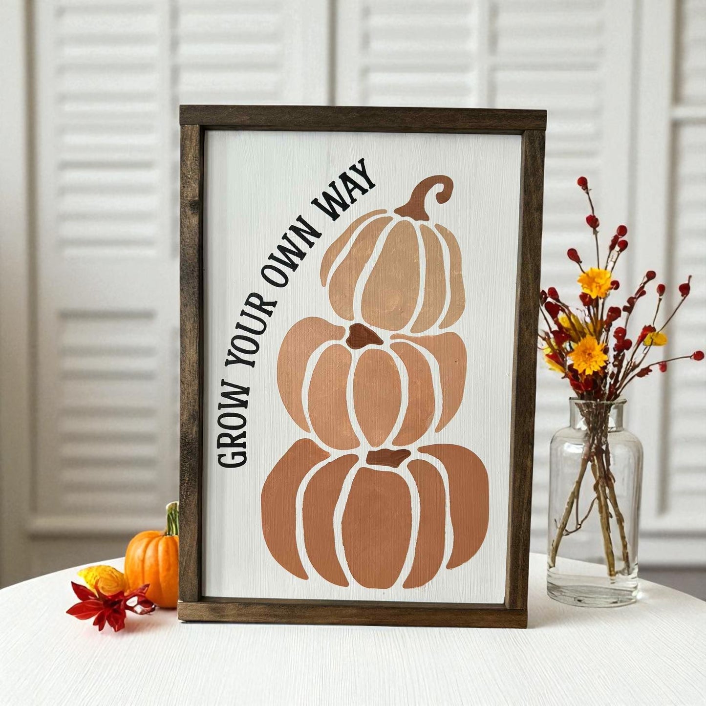 Hand-painted framed wood sign with stacked pumpkins and inspirational saying Grow Your Own Way – unique fall decorating idea