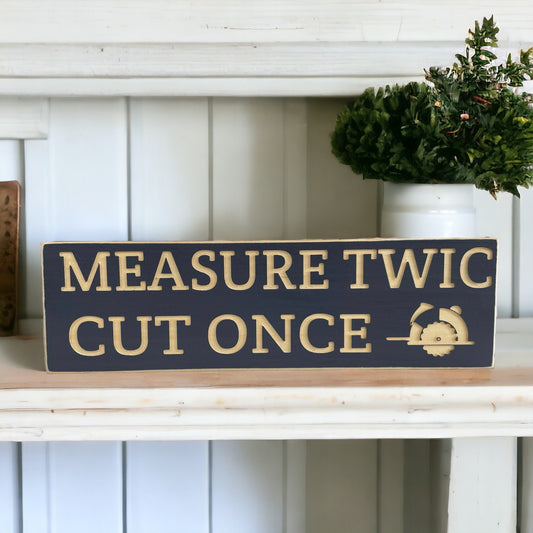 Carved wood sign reading 'Measure Twic and Cut Once' - perfect funny gift for him