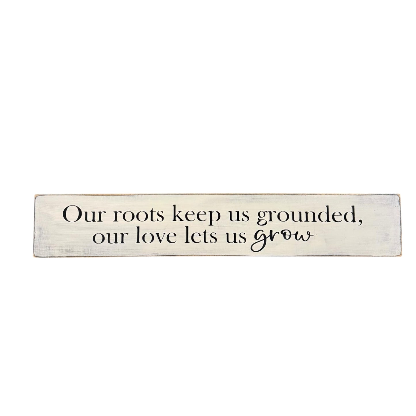 Wooden sign that reads “Our roots keep us grounded, our love lets us grow” – a white hand-painted housewarming gift for couples.