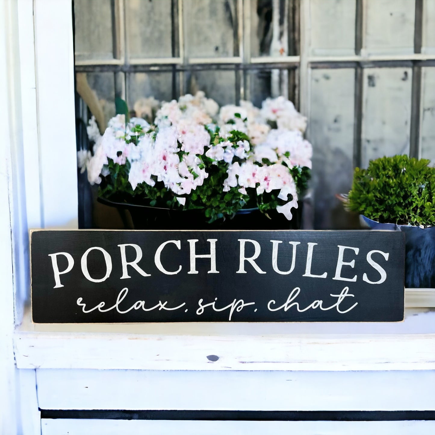 Black wood porch sign with 'Relax, Sip, Chat' in white text, measuring 4 inches by 24 inches