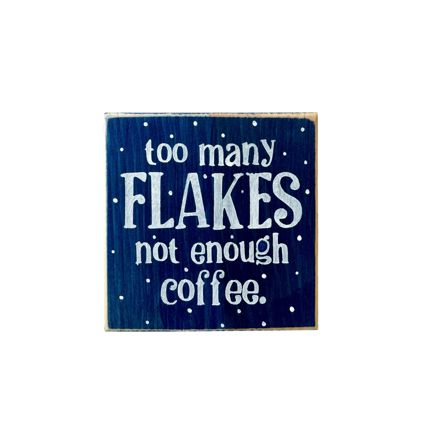 Handpainted wood block sign reading “Too Many Flakes, Not Enough Coffee” in white text on a navy blue background, surrounded by snowflakes, ideal for winter decor and coworker gifts.