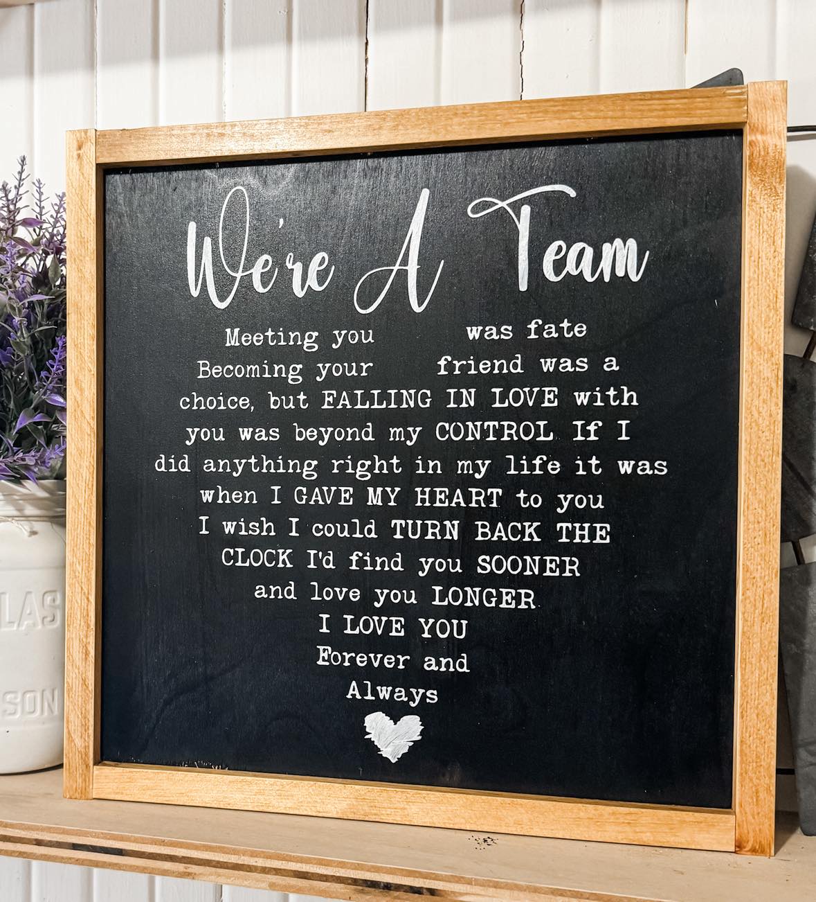 Framed wood sign that reads “We’re A Team” in a heart shape – cute couple quote anniversary gift