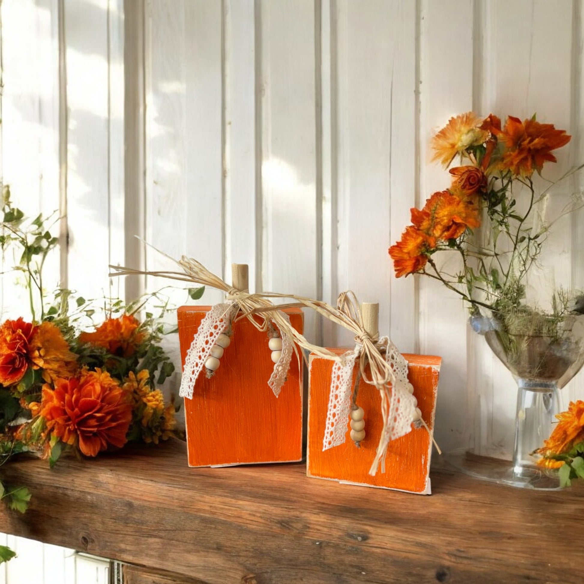 Handcrafted wooden pumpkin decorations with raffia, lace ribbon, and beads for fall home decor.