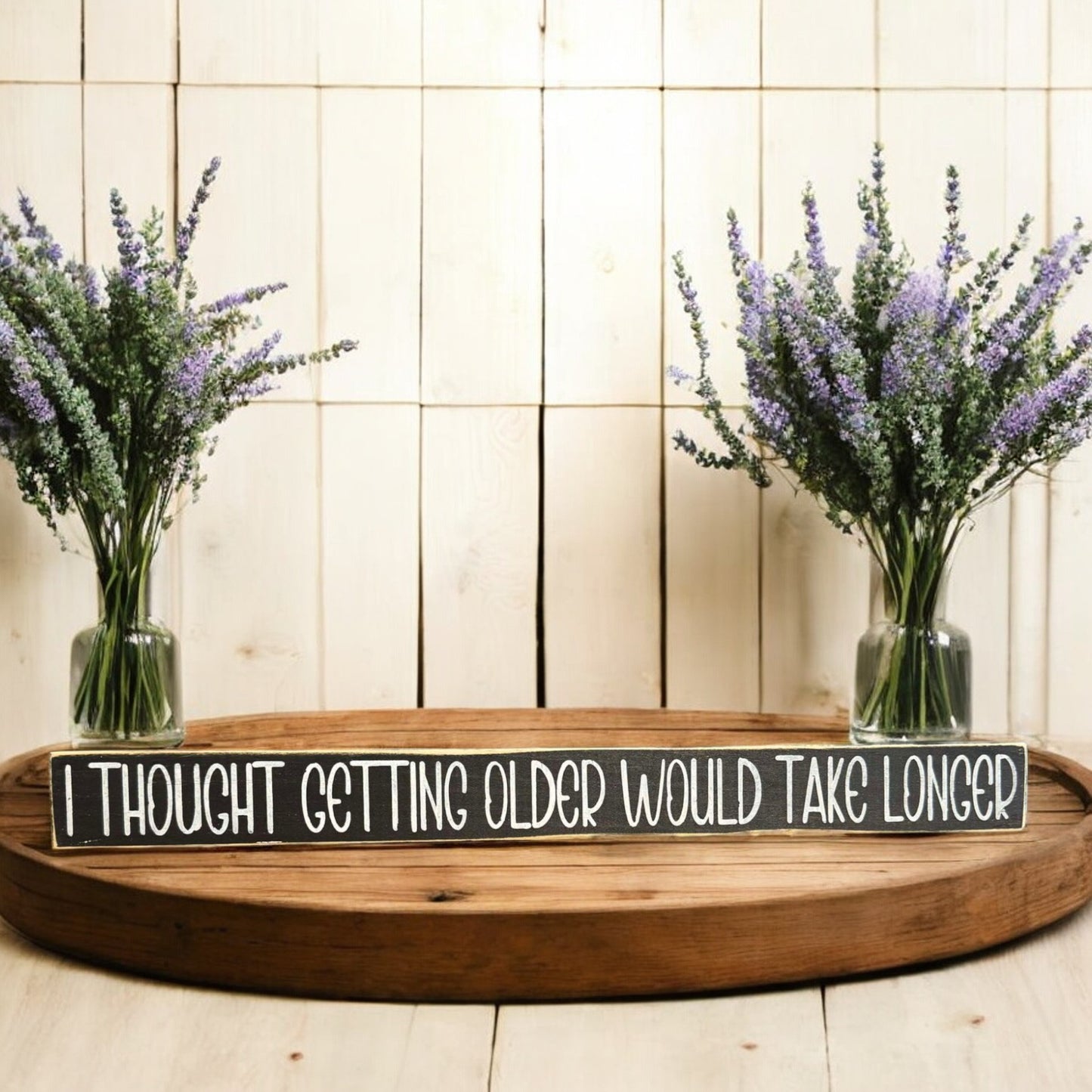 Black and white wooden sign with text reading 'I Thought Getting Older Would Take Longer' - perfect for funny age quotes and humor decor.