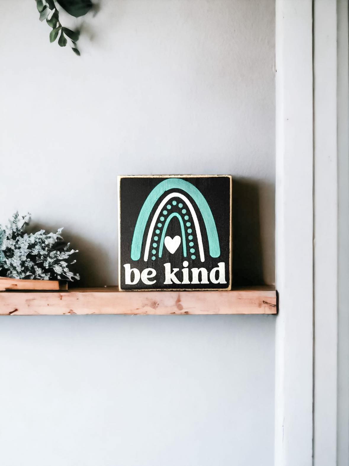 Be Kind" Wood Block Sign: Hand-painted white text on black background with rainbow accent, 4.5"x4.5". Ideal for spreading positivity.