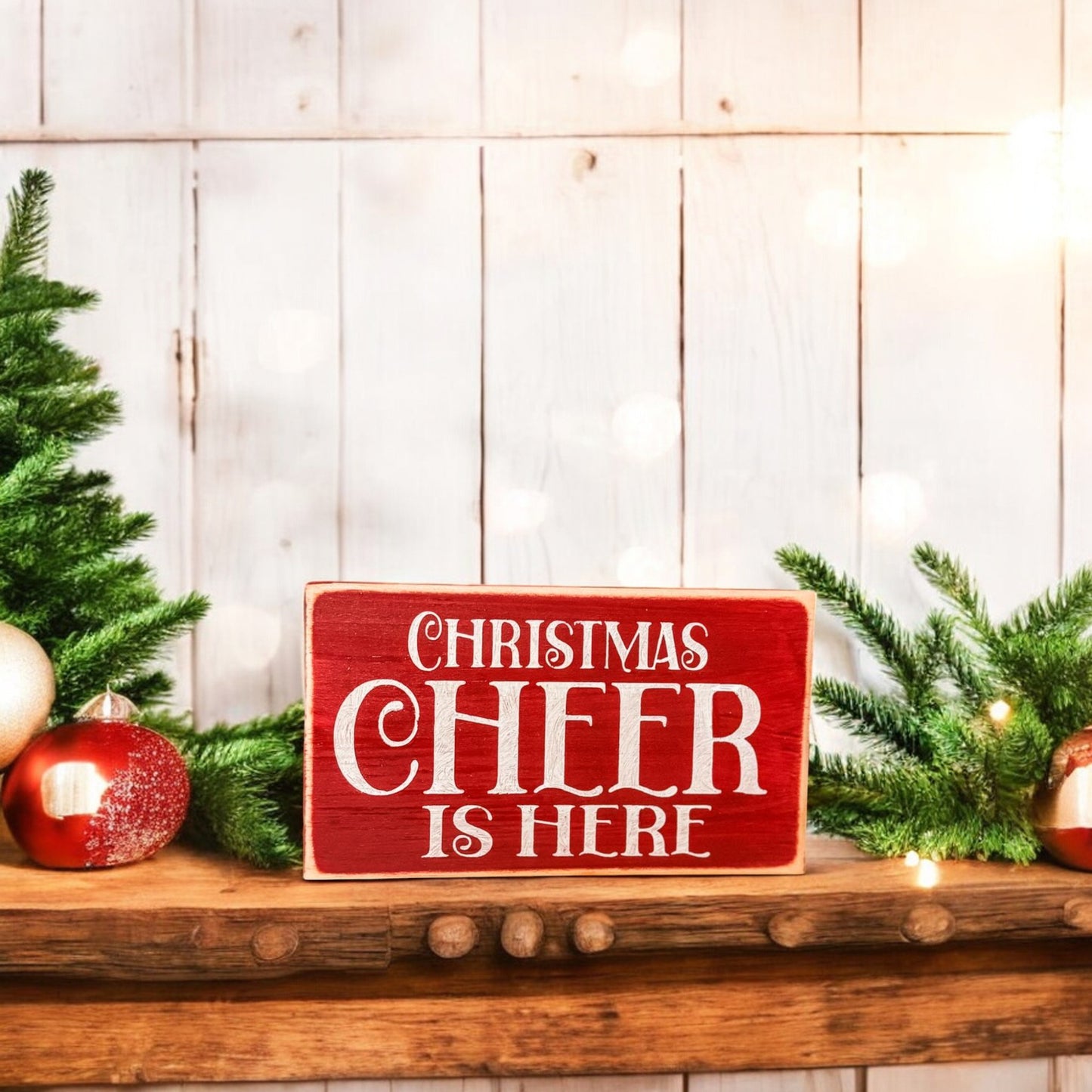 3.5" x 6" wood block sign reading "Christmas Cheer is Here," handpainted in festive holiday red with white text.