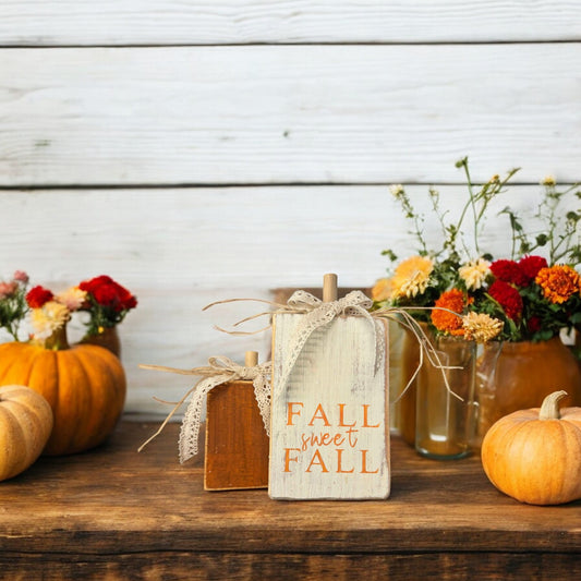 Handcrafted wood pumpkins for fall decor—one orange and one distressed white with "Fall Sweet Fall," ideal for shelf sitters and seasonal home accents.