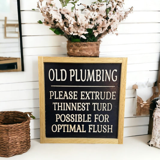 Carved wooden sign for farmhouse bathroom decor, featuring humorous 'Old Pumping: Please Extract Thinnest Turd Possible For Optimal Flush' joke, natural wood on black.