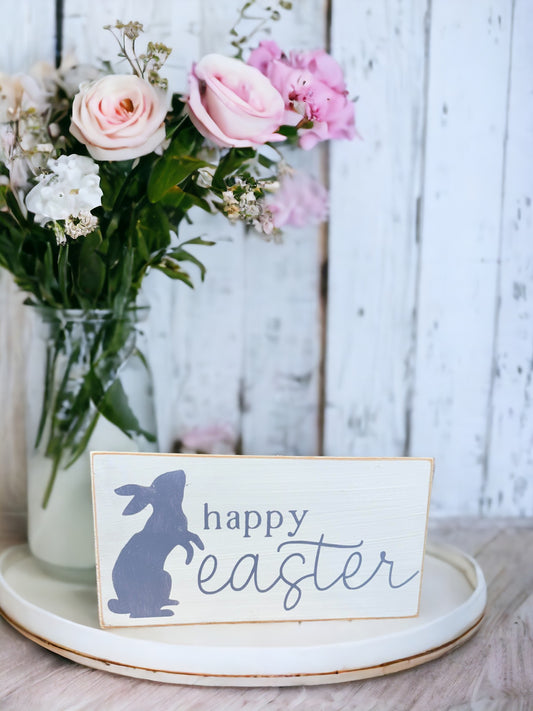Hand-painted white wood sign with lavender 'Happy Easter' text and adorable bunny illustration