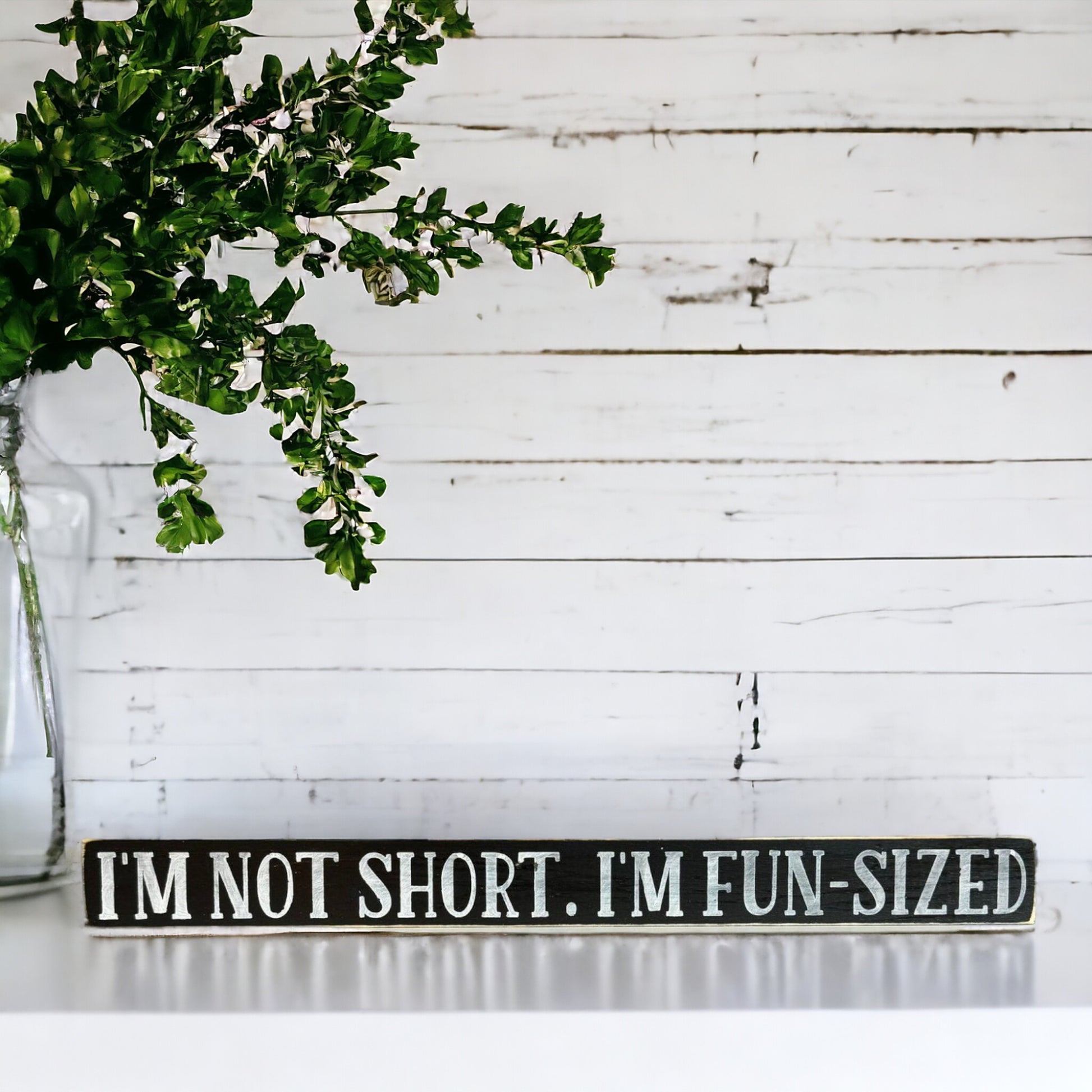 Handpainted black wood sign with white text reading 'I'm Not Short, I Am Fun Sized,' freestanding 16-inch funny decor for gifting to friends with a great sense of humor.