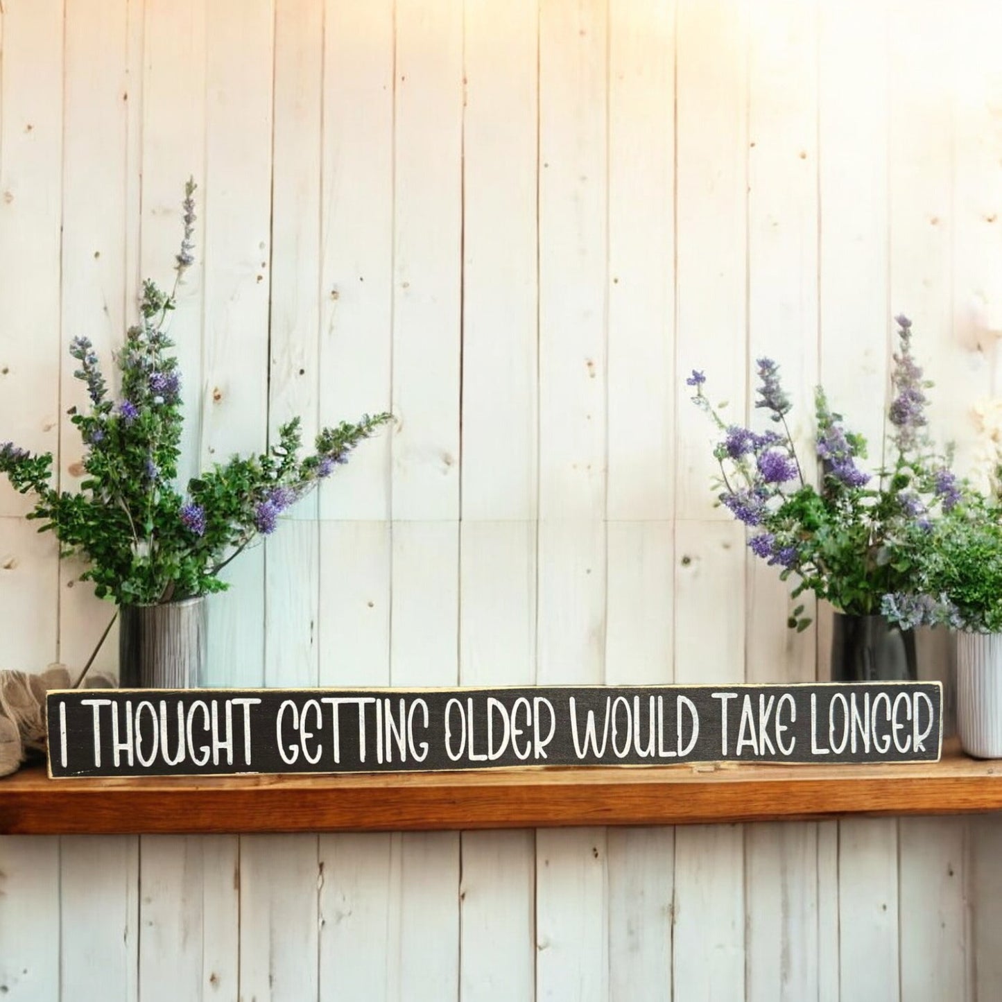 Black and white wooden sign with text reading 'I Thought Getting Older Would Take Longer' - perfect for funny age quotes and humor decor.