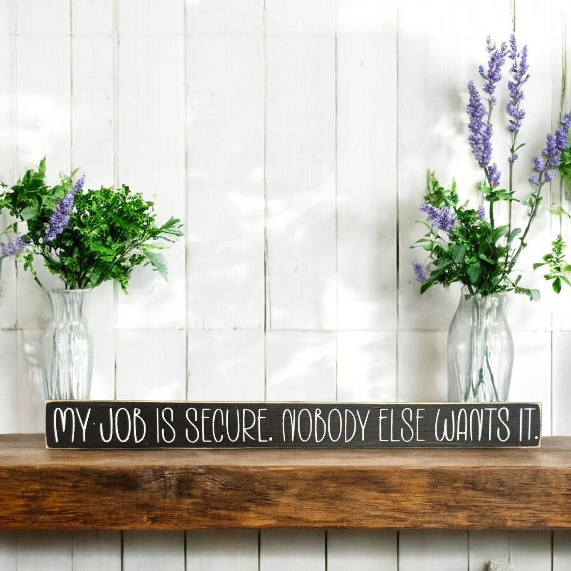 Black and white wood sign with text reading 'My Job Is Secure. Nobody Else Wants It' - ideal funny sign for office and desk sign with office humor.