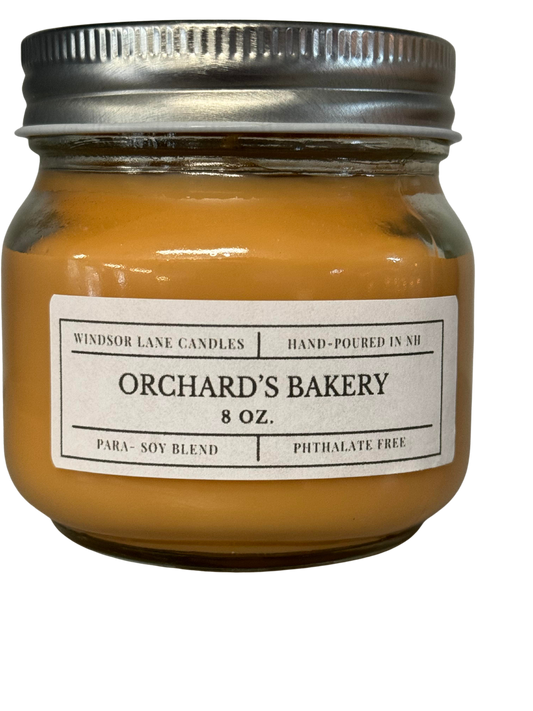 A sensory delight captured in the Orchards Bakery scented Mason Jar Candle. Fragrance notes include apple, cider, donut, cinnamon, vanilla, sugar, tonka bean, and musk, creating an inviting and comforting atmosphere.