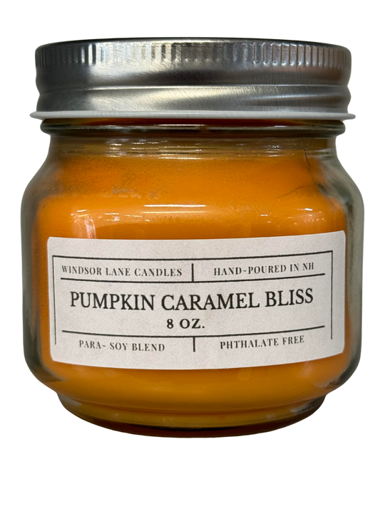 A harmoniously warm and inviting Pumpkin Caramel Bliss Mason Jar Candle with notes of caramel, pumpkin, spice, cream, cinnamon, and brown sugar, creating an inviting and cozy ambiance.