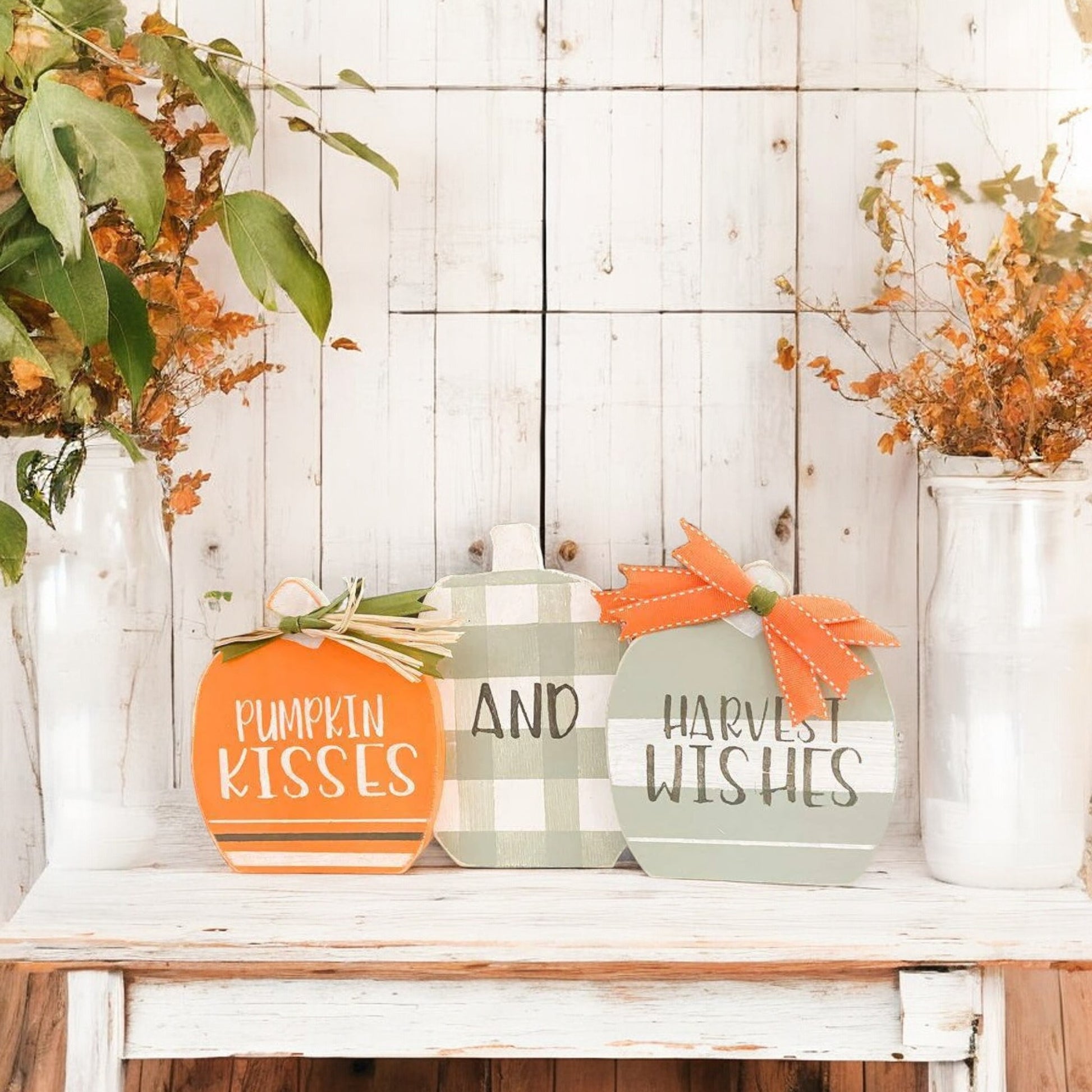 Three joined wooden pumpkins with "Pumpkin Kisses And Harvest Wishes" hand-painted on them, designed as a shelf sitter for Autumn decor.