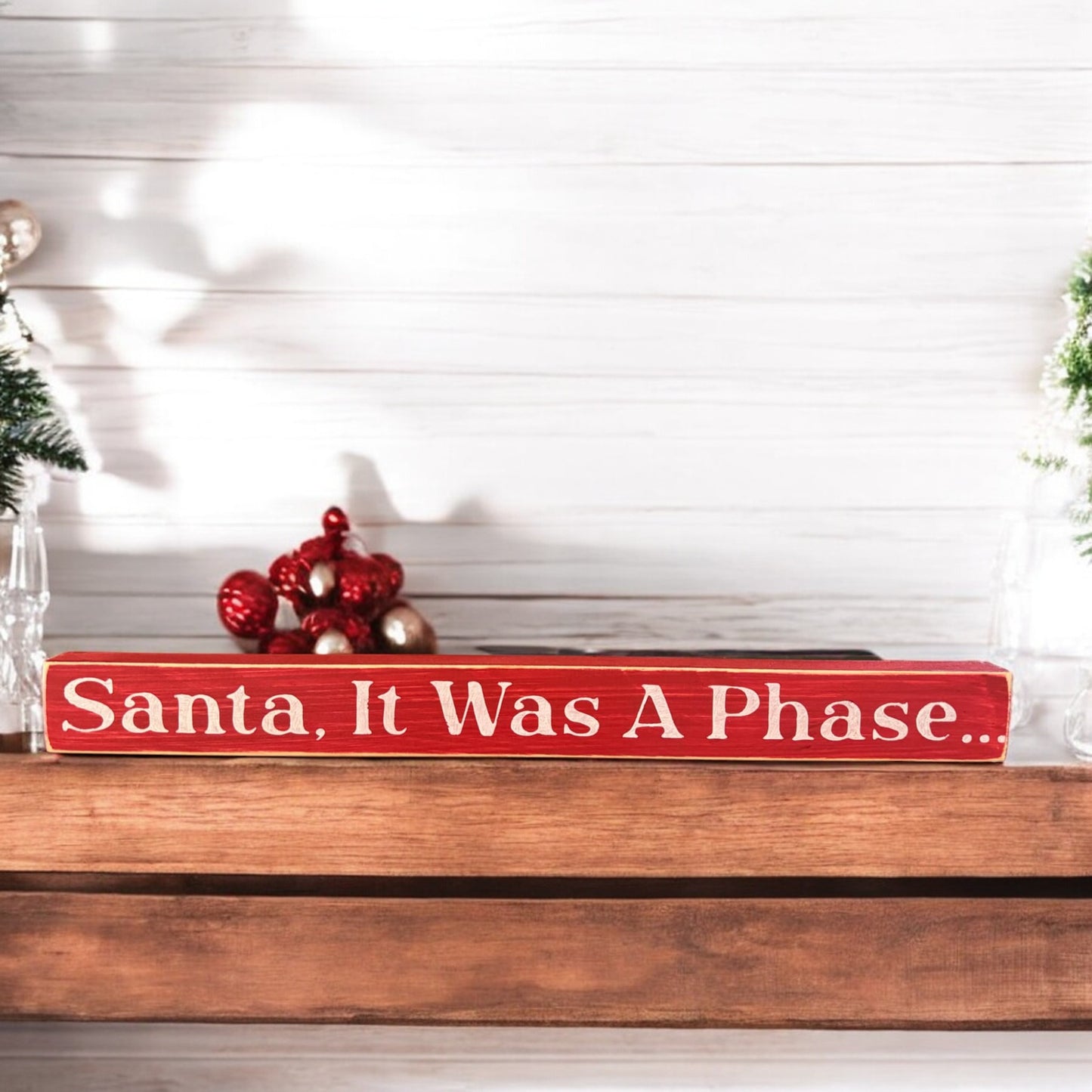 Red wood sign with 'Santa, It Was A Phase' in white, holiday decor for mantel or cubicle