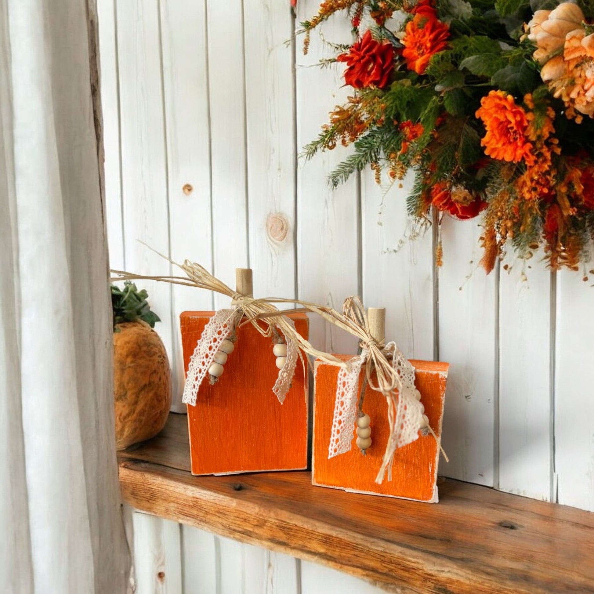 Handcrafted wooden pumpkin decorations with raffia, lace ribbon, and beads for fall home decor.