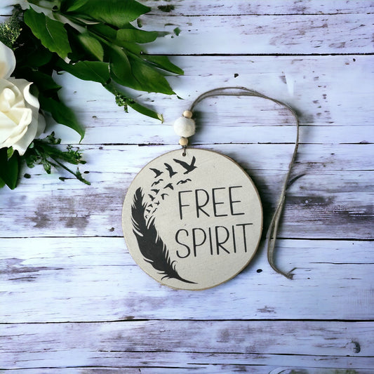 4-inch wooden car charm reading 'Free Spirit' with grey text, hanging car decoration.