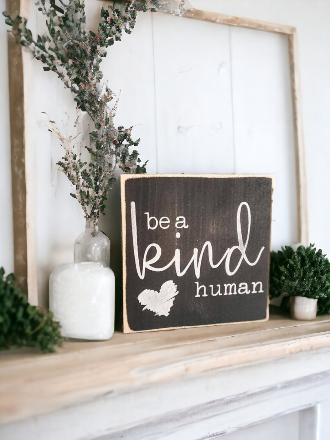 Be A Kind Human" wooden block sign with black background and white text, featuring a heart icon. Ideal for office desk decor or shelf display