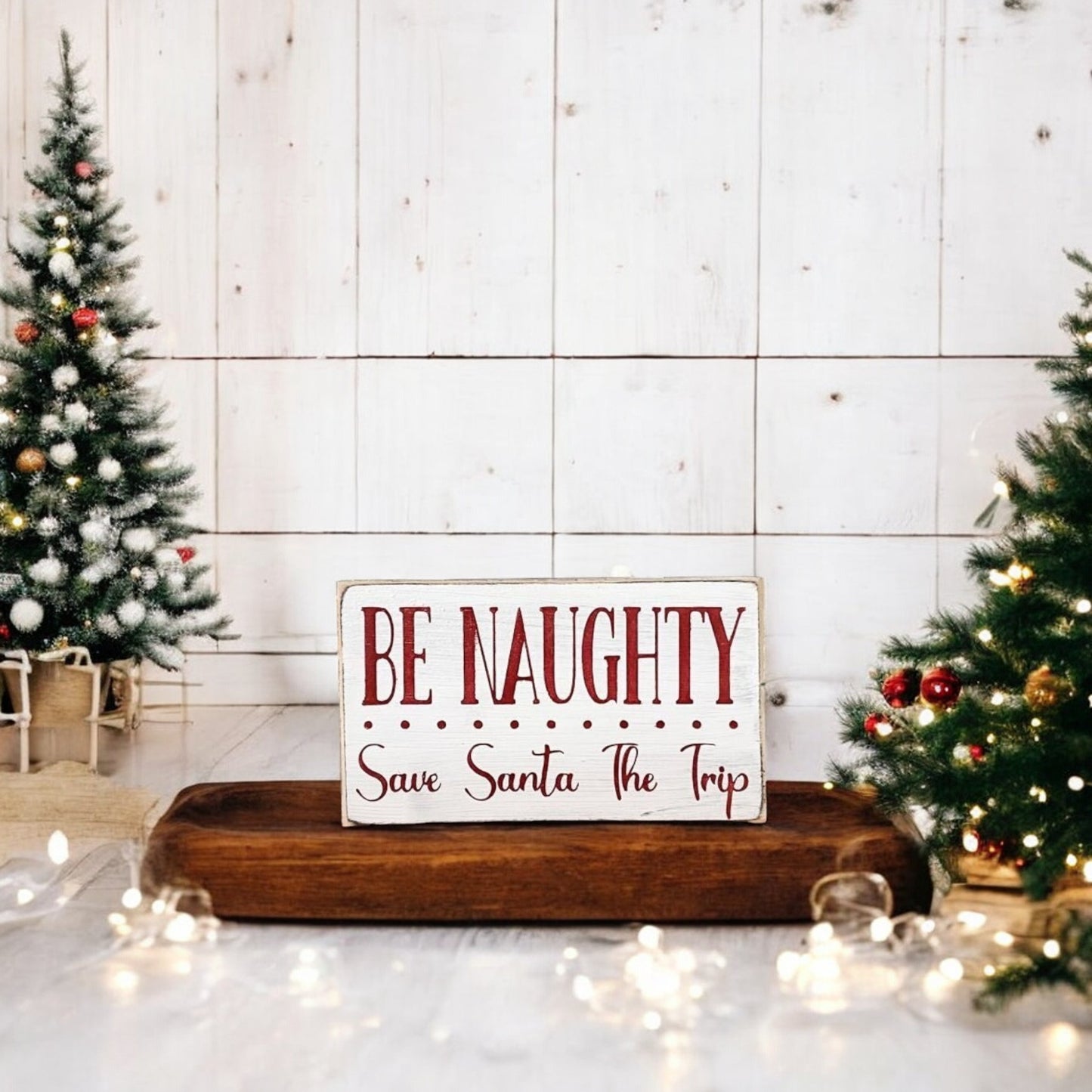 Handpainted "Be Naughty, Save Santa the Trip" wood block sign with red text on a white background, perfect for Christmas holiday humor.






