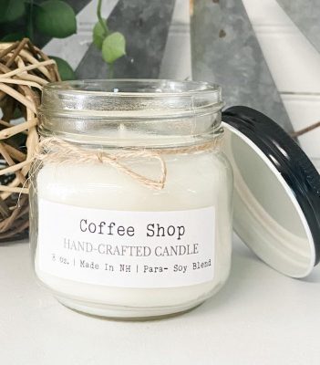 A phthalate-free Coffee Shop Mason Jar Candle, meticulously hand-poured with high-quality 8 oz para-soy wax and fragrant oils. This inviting candle envelops your space in the rich and comforting scent of freshly brewed coffee, creating a cozy atmosphere reminiscent of your favorite neighborhood café.