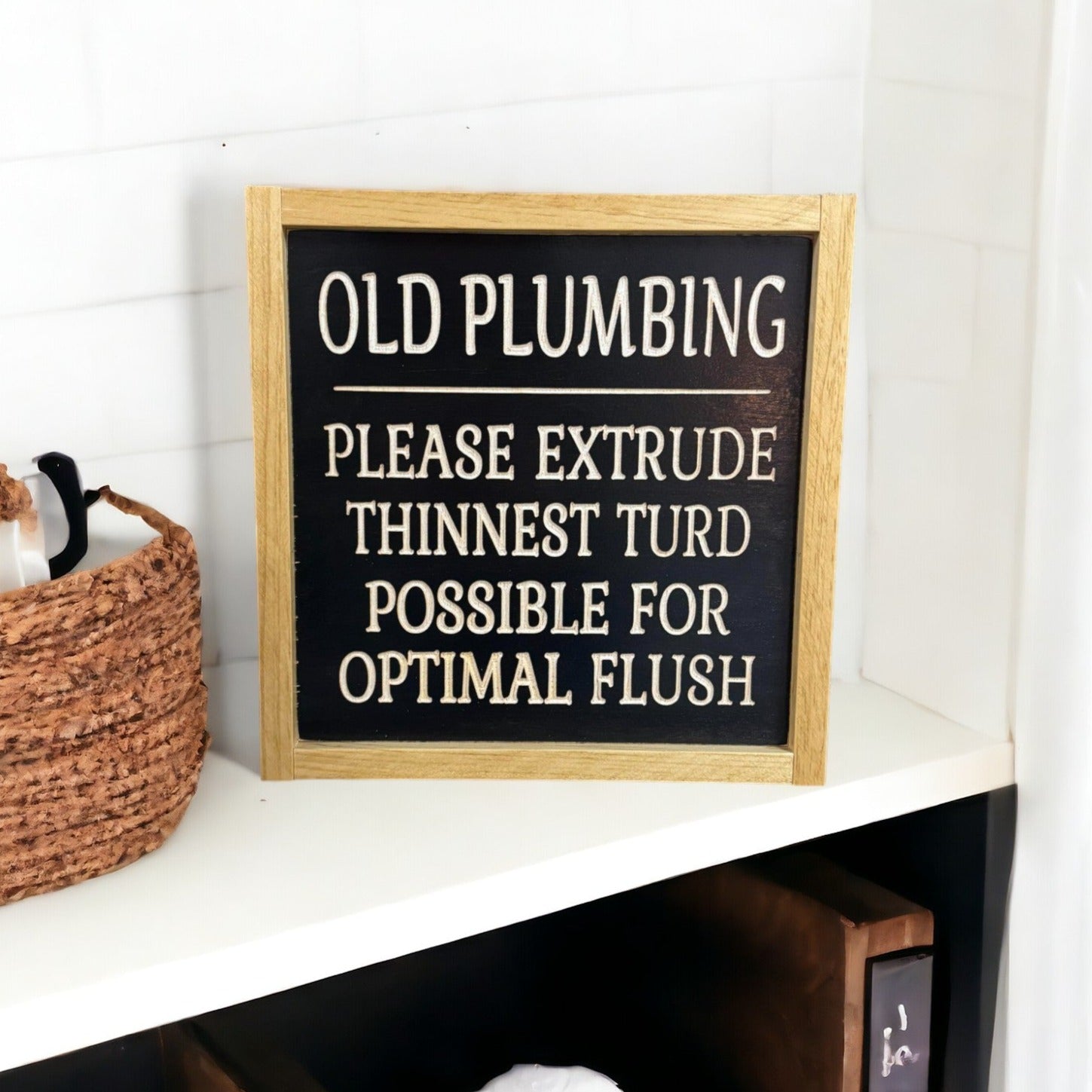 Carved wooden sign for farmhouse bathroom decor, featuring humorous 'Old Pumping: Please Extract Thinnest Turd Possible For Optimal Flush' joke, natural wood on black.