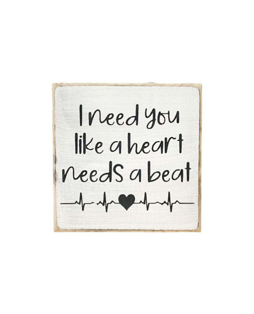I Need You Like a Heart Needs a Beat" Love Sign: Hand-painted black text on white background, 4.5" x 4.5". Ideal relationship gift.