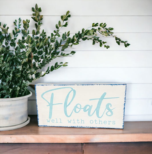 Floats Well With Others" wood sign in blue and white, perfect for lakehouse decor and birthdays for water lovers