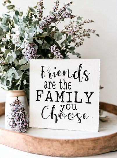 Friends are the family you choose" - a 5.5" x 5.5" wood block sign with black text on a white background.