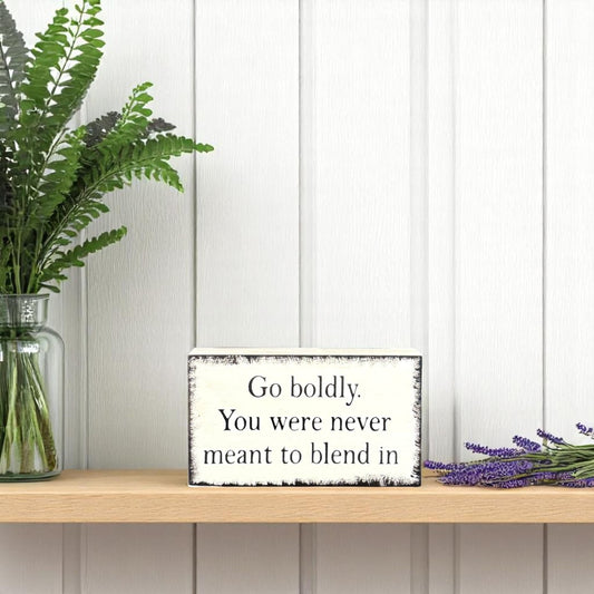 Freestanding farmhouse wood block sign that reads “Go Boldly. You Were Never Meant to Blend In”