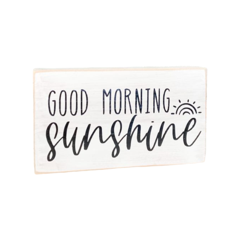 A 3.5" x 6" wood block sign with a white background and sleek black text that reads, 'Good Morning Sunshine.' This wood block sign is the perfect bedside table decor, designed to add a touch of positivity and motivation to your bedroom.