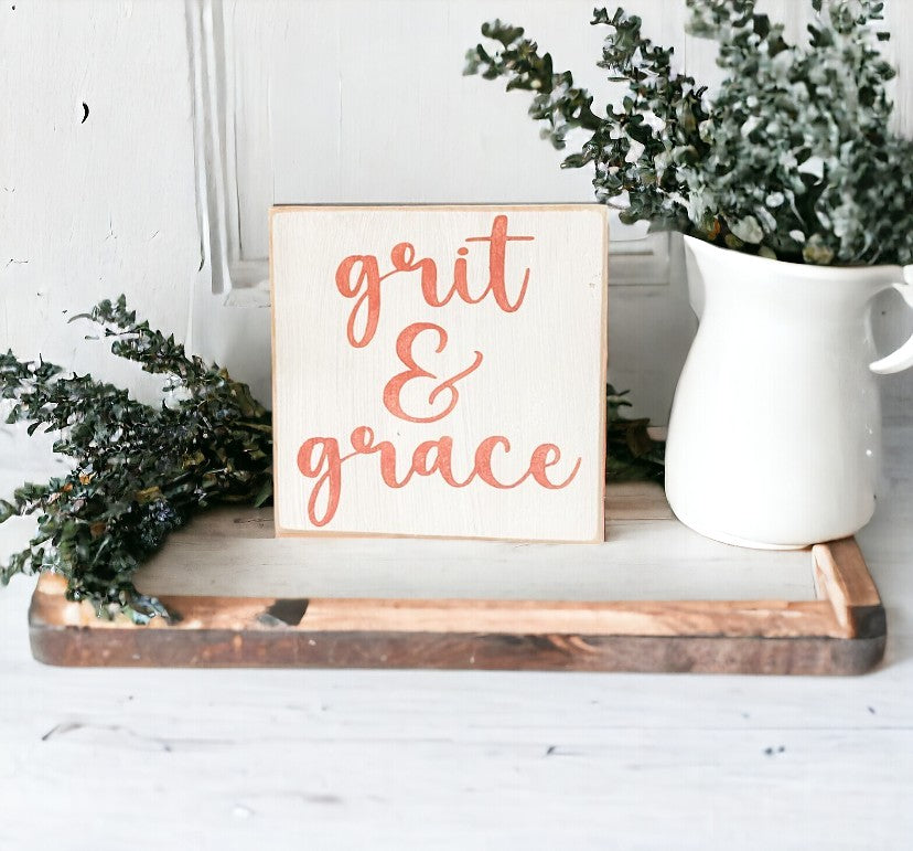 Grit and Grace" Desk Sign: Hand-painted pink text on white background, 5.5" x 5.5". Inspirational decor for desks.