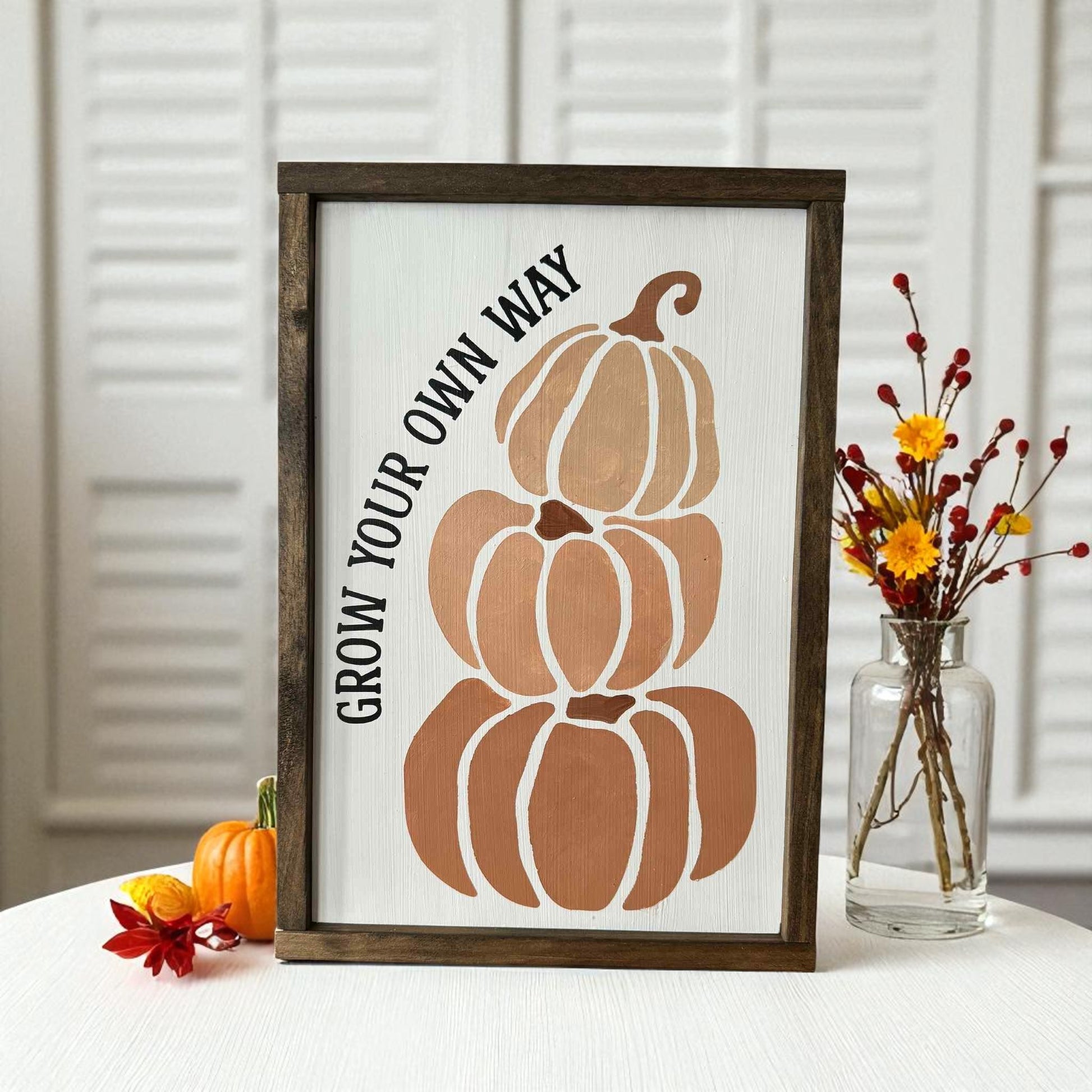 Hand-painted framed wood sign with stacked pumpkins and inspirational saying Grow Your Own Way – unique fall decorating idea

