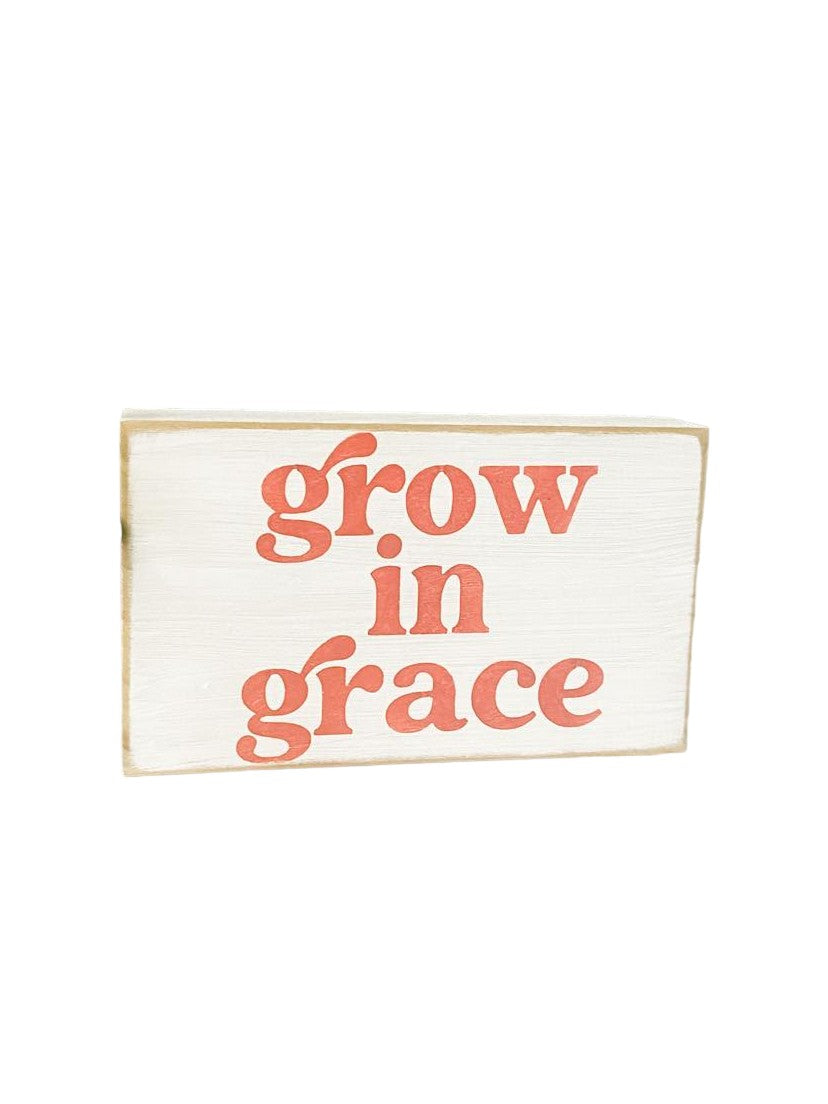 Grow in Grace" Scripture Art Wood Block Sign: Hand-painted pink text on white background, 3.5" x 6". Perfect for spiritual decor.