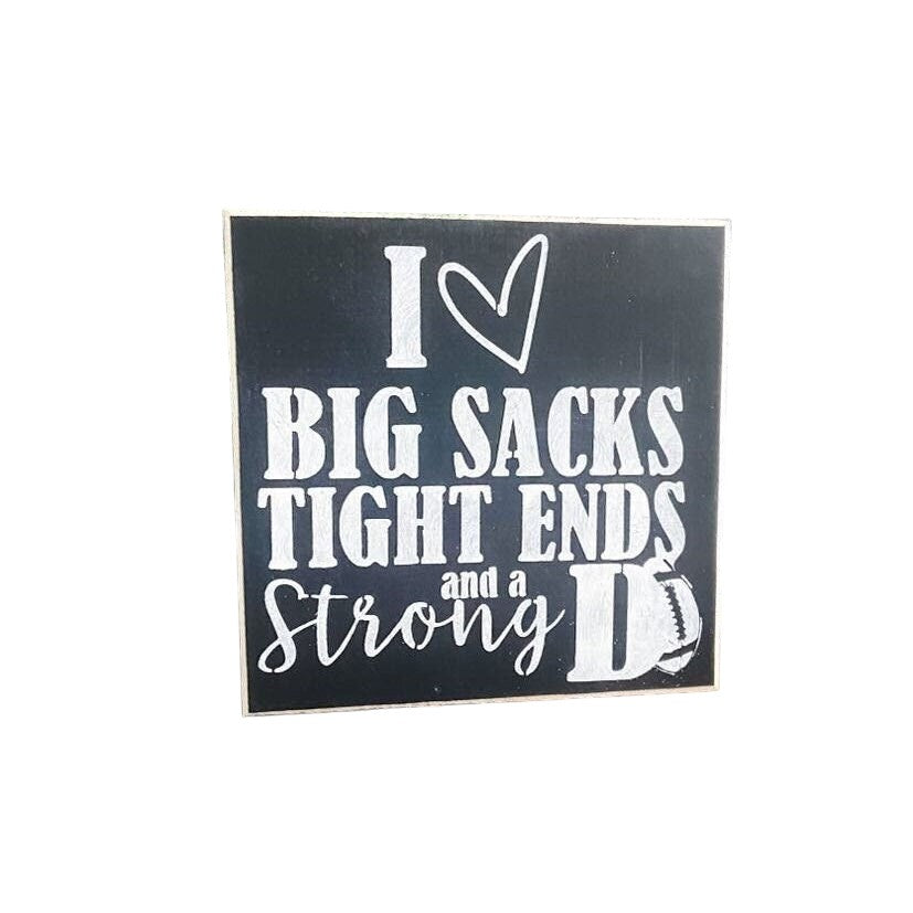 Mini wood football sign with humorous phrase "I love big sacks, tight ends, and a strong D", measuring approximately 5.5" x 5.5