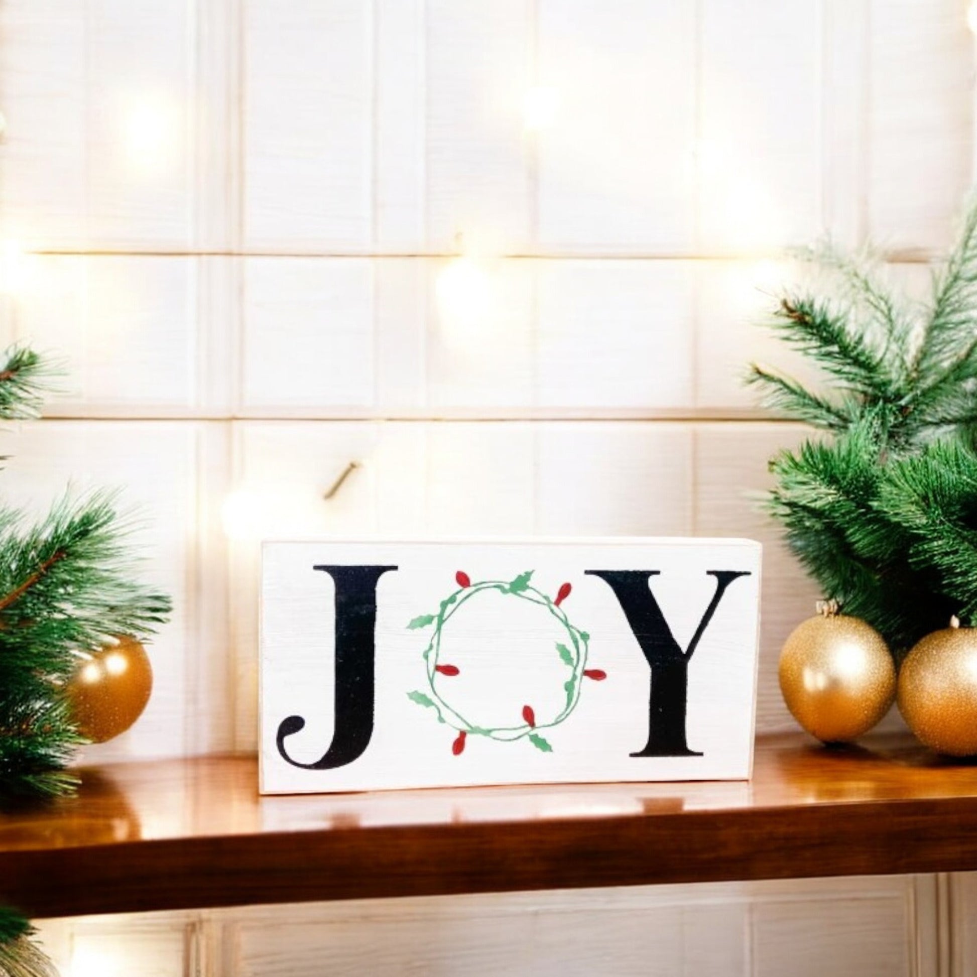 "Joy" wood sign with a wreath of Christmas lights as the "O," perfect for mantels, offices, and shelves.