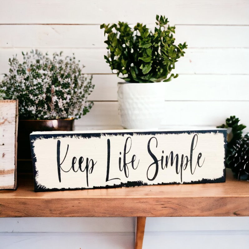 Keep Life Simple" wood sign with elegant black text on white background and artistic brush strokes, ideal for home decor