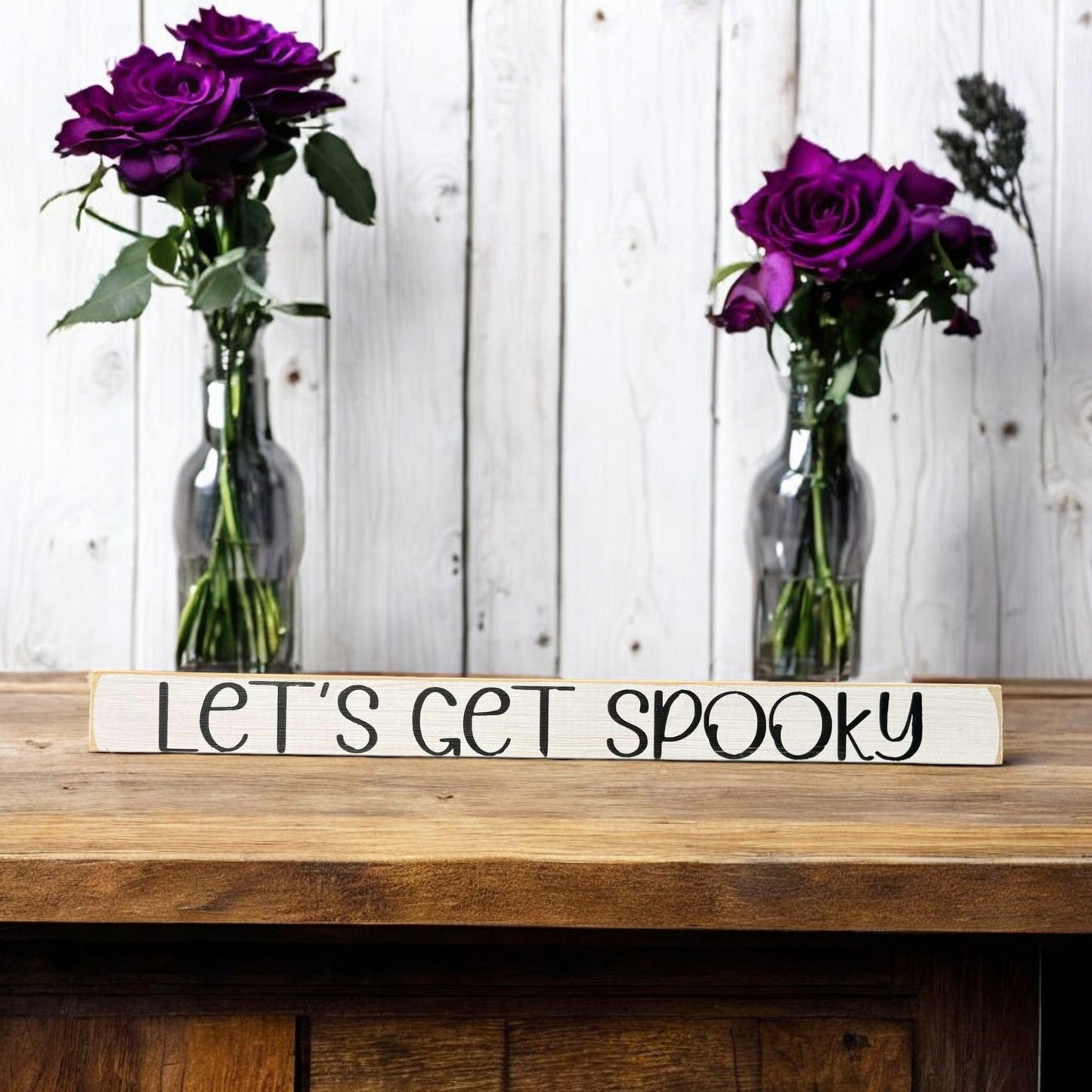 Skinny wooden Halloween sign with "Let's Get Spooky" text in black on a white background, ideal for Halloween decor and a ghost sign on a shelf, mantel, or office.