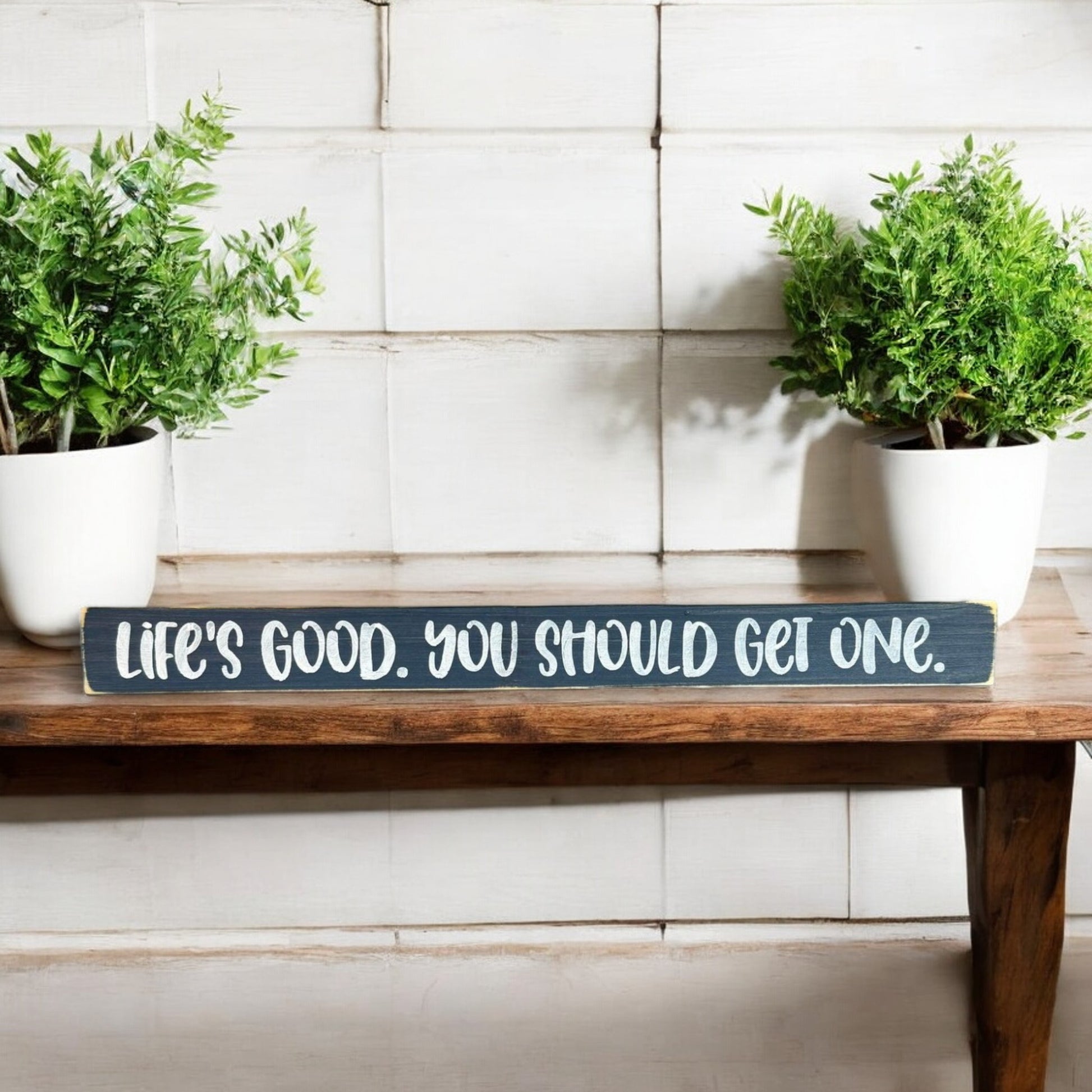 Hand-painted 1.5" x 16" skinny wood sign that reads "Life's Good You Should Get One" in white text on a bluish-gray background, perfect for farmhouse-style shelf decor.