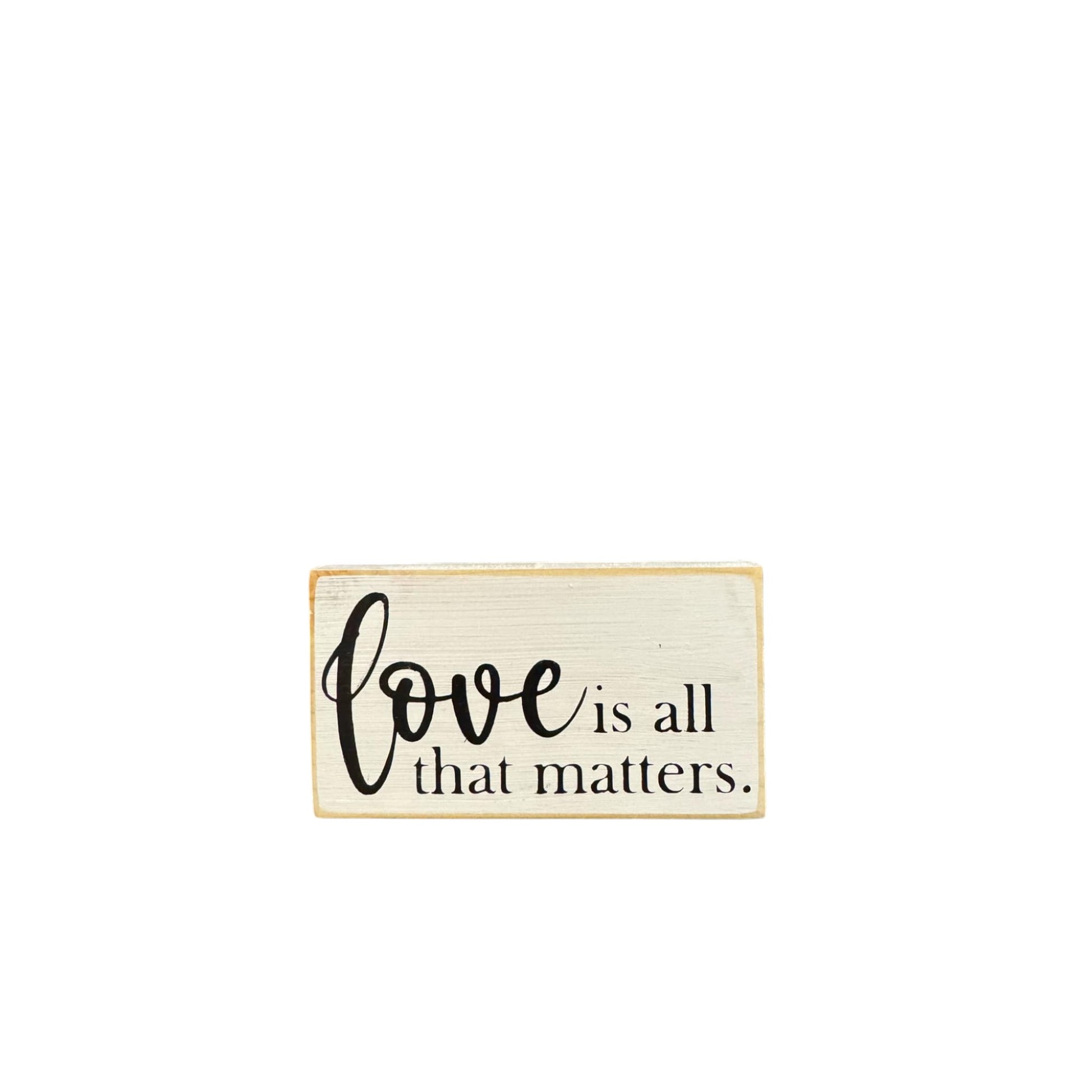 Rustic small wood sign reading 'Love is all that matters,' hand-painted white with black text for Valentine's Day decor or gifting