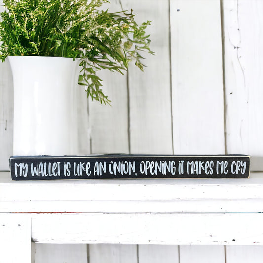 Handpainted black wood sign with white text reading 'My Wallet Is Like An Onion, Opening Makes Me Cry,' freestanding 16-inch funny wood sign with a money joke for home or office decor.