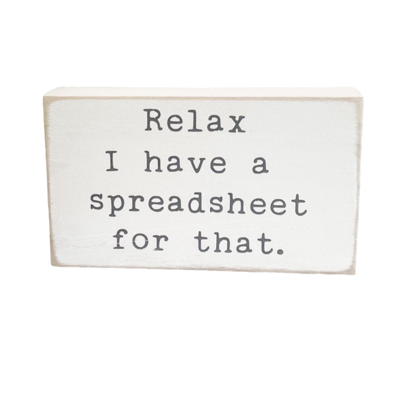 Image: A 3.5" x 6" wood desk sign in crisp white with playful typewriter gray text that reads, 'Relax, I have a spreadsheet for that.' Perfect for gifting to the spreadsheet enthusiast in your life, this compact sign adds a touch of organized humor to any desk, office shelf, or bookcase.