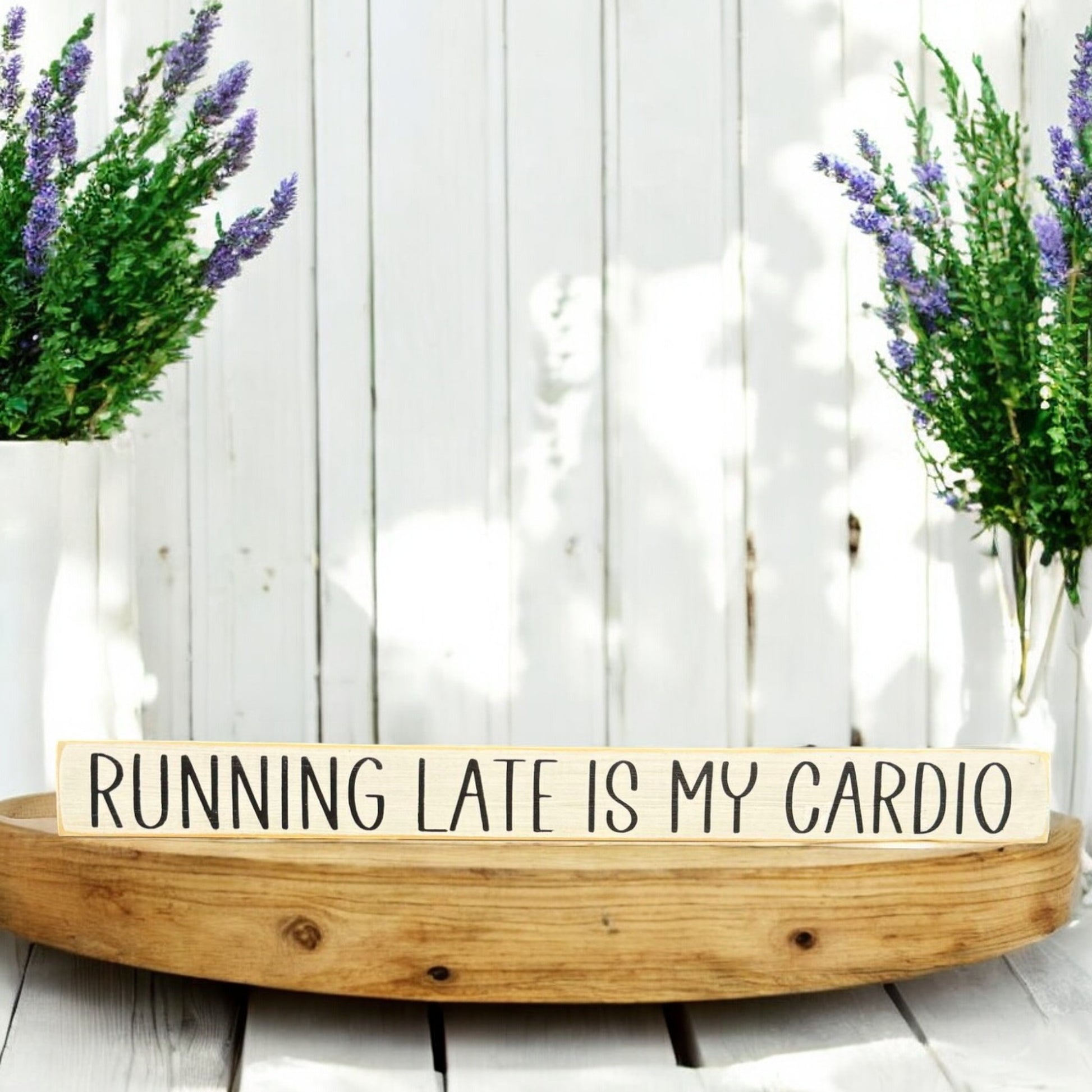 White wood sign with black text reading 'Running Late is My Cardio' - ideal funny office sign with sarcastic humor.