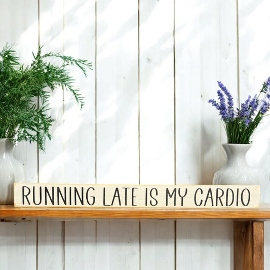 White wood sign with black text reading 'Running Late is My Cardio' - ideal funny office sign with sarcastic humor.