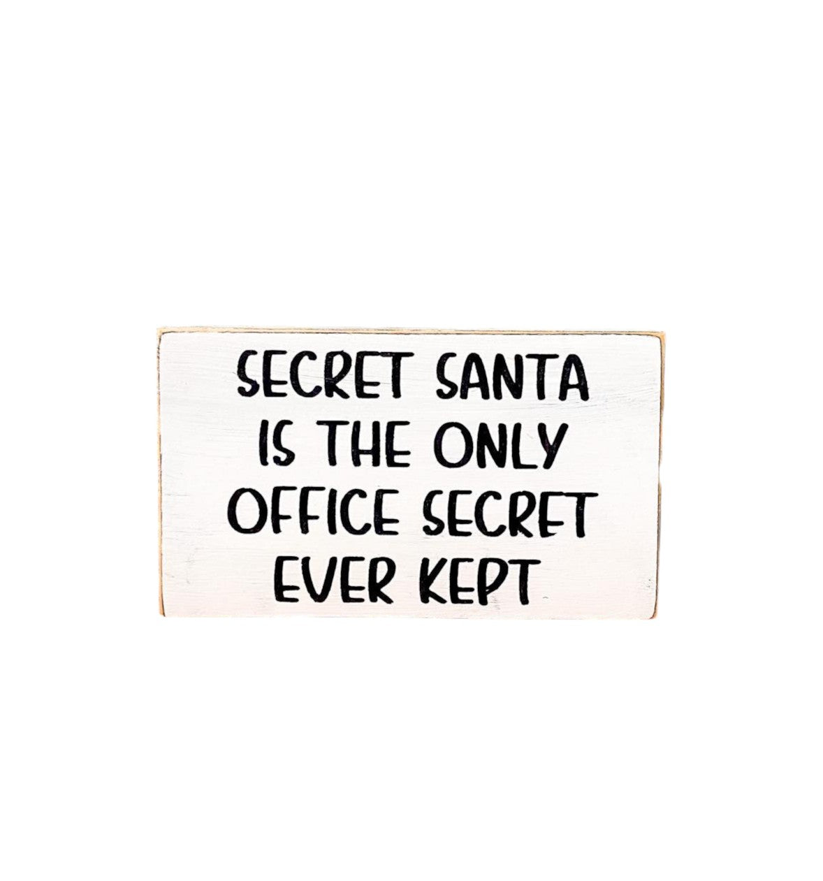 3.5" x 6" wood block sign reading "Secret Santa is the only office secret ever kept," handpainted with a white background and playful black text.