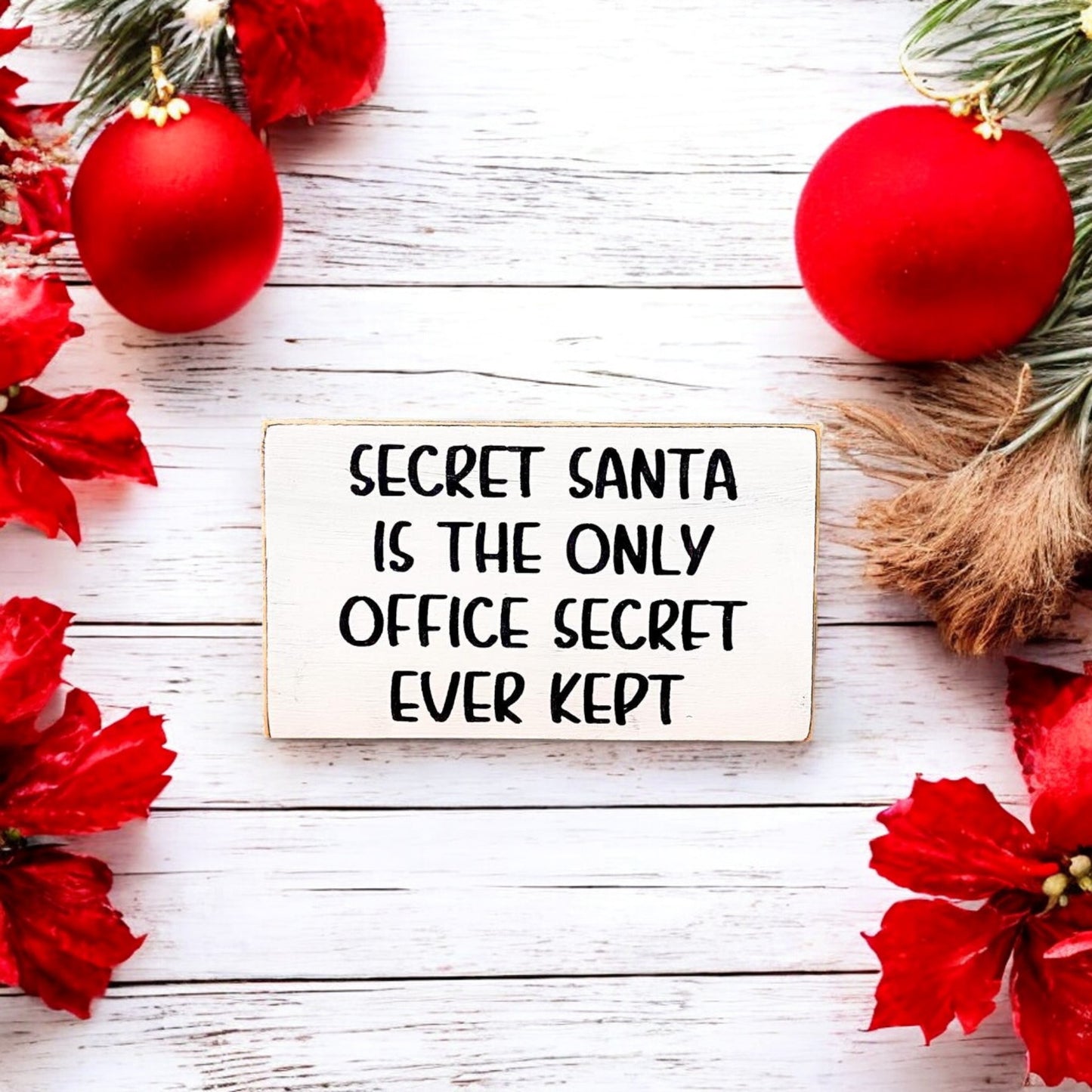 3.5" x 6" wood block sign reading "Secret Santa is the only office secret ever kept," handpainted with a white background and playful black text.